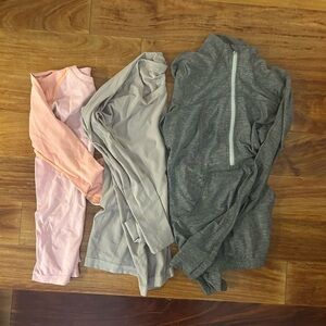 Lululemon Set of Three Long Sleeve Tops in Pink, Gray, and Dark Gray